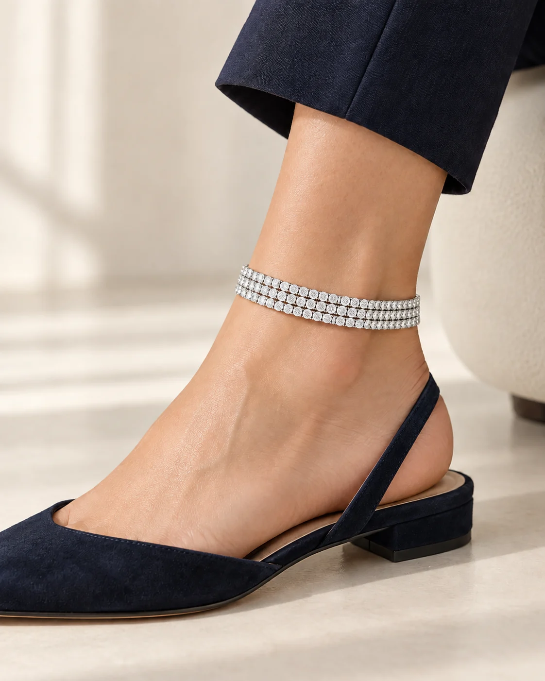 AI development concept of a three-row clear rhinestone anklet with a navy shoe