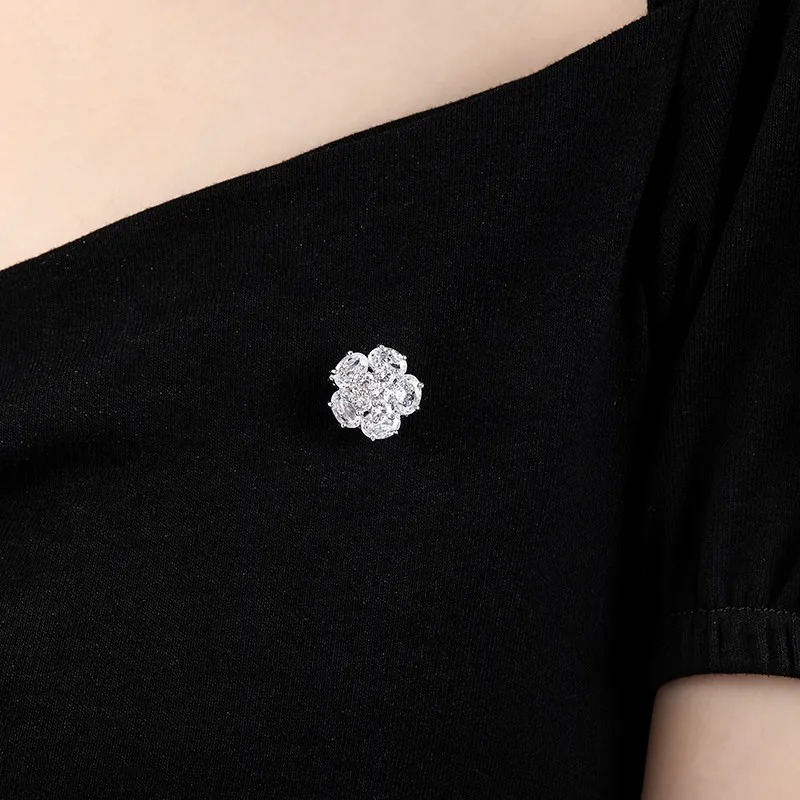 Clear crystal flower brooch styled on black apparel